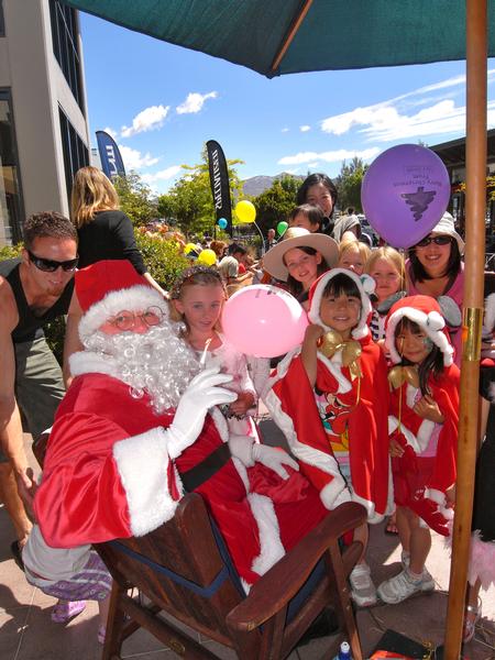 Santa entertains children during a Christmas Fun Day at Remarkables Park Town Centre.
